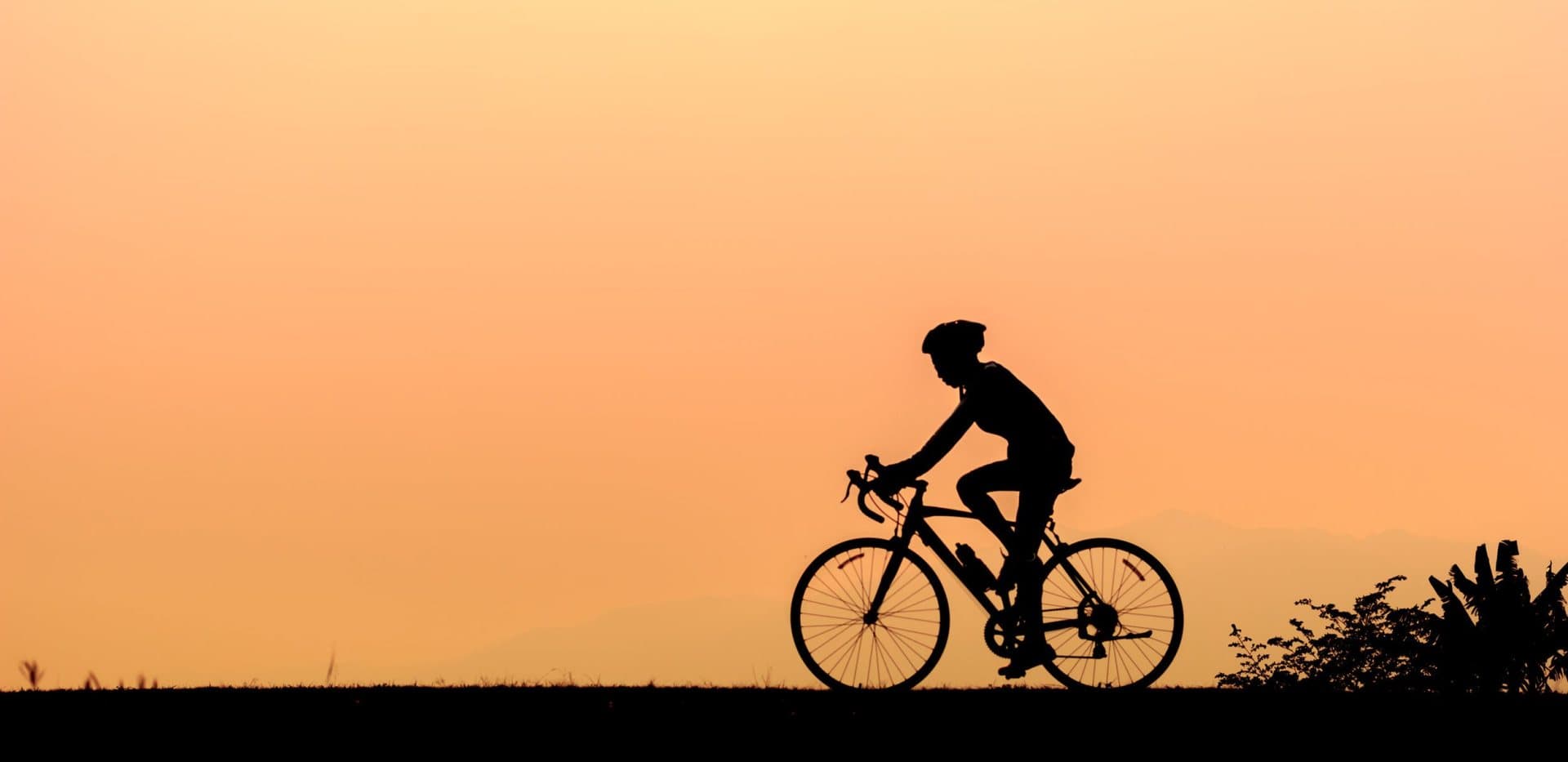 A cyclist on a ridge at sunset