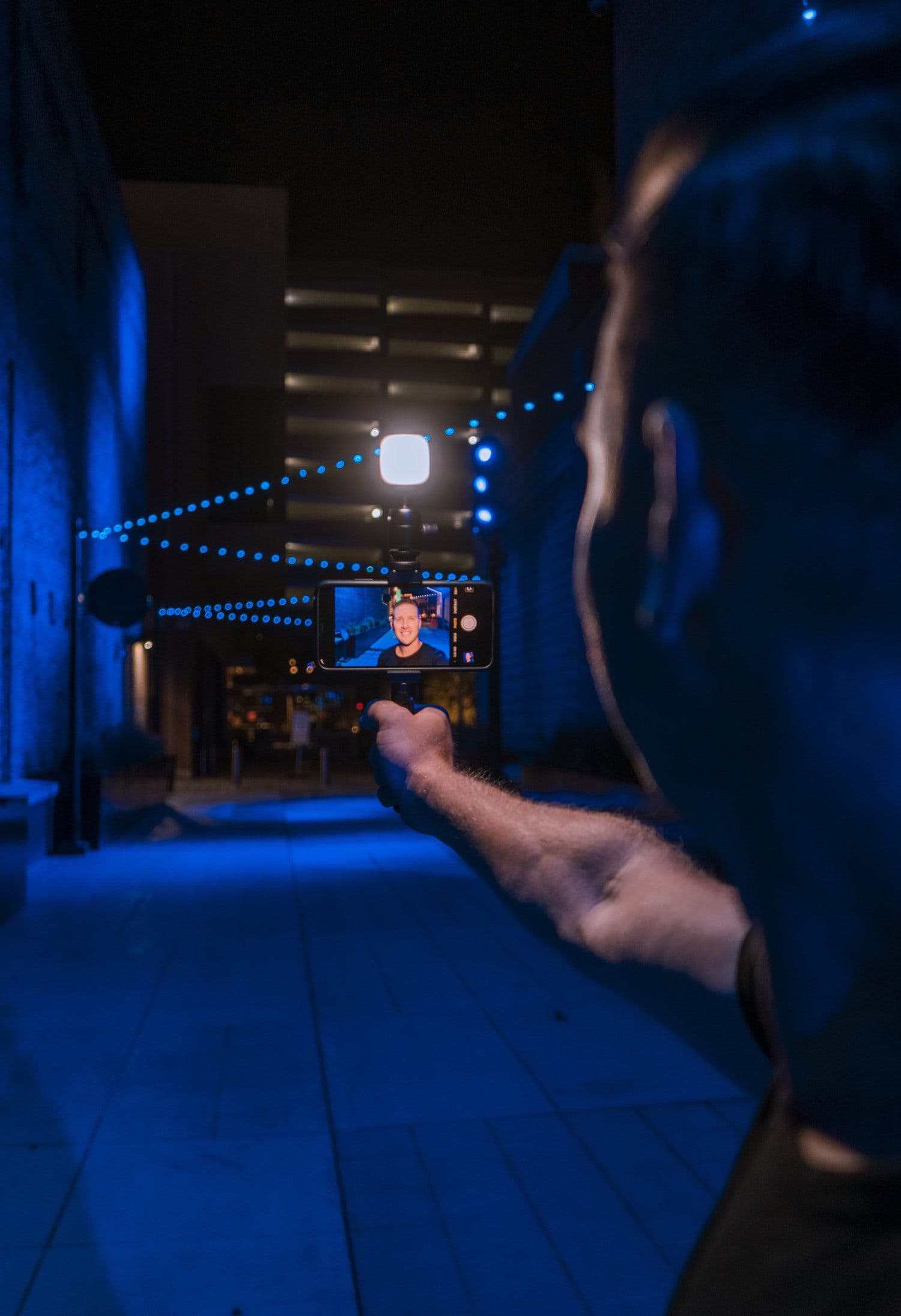 A creator lighting a night scene with a Litra light