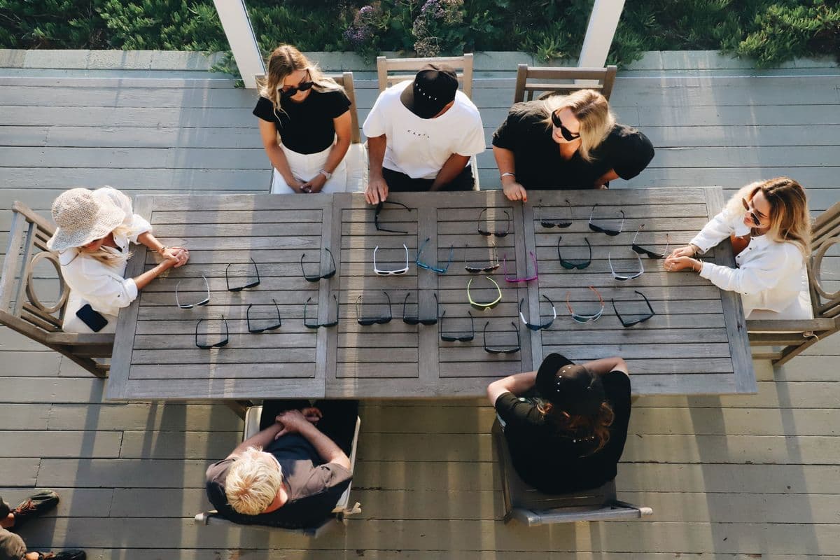 The crew seen from above, laying out CARVE frames on a long outdoor table
