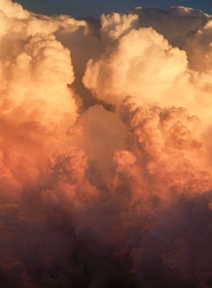 A cumulonimbus cloud rising over the Pacific at golden hour