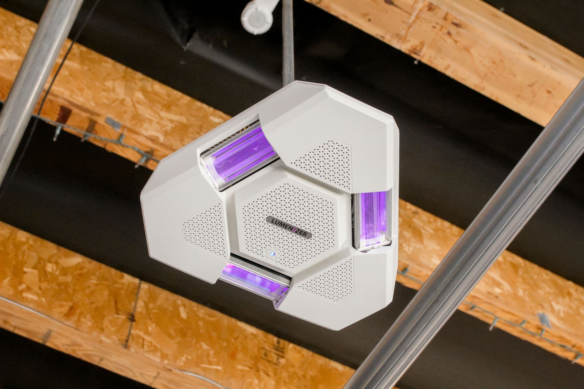 A Lumenizer air-disinfection unit mounted under exposed ceiling beams
