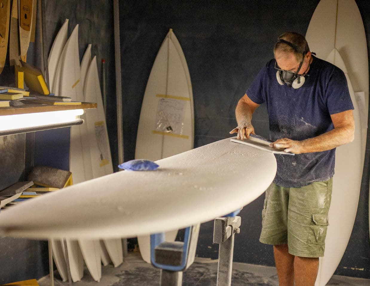 A shaper finishing a board at the Rusty factory